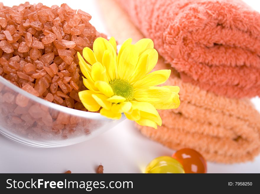 Spa pruducts: bath salt, oil balls, towels and flower
