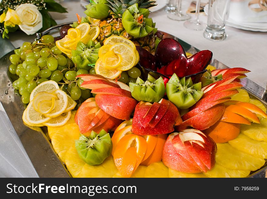 Dish with a fruit dessert on a beautiful celebratory table. Dish with a fruit dessert on a beautiful celebratory table.