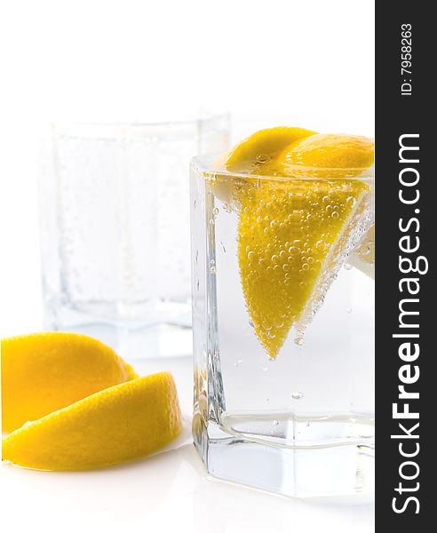 Glass with soda water and lemon slices
