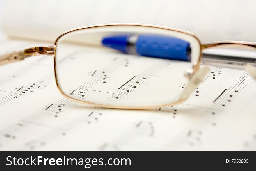 Glasses and pencil on book