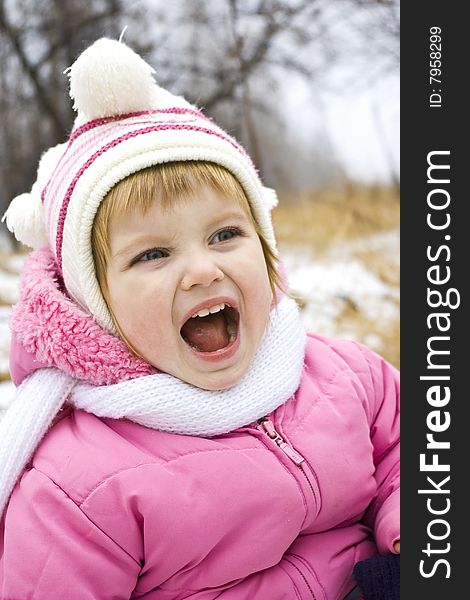 ï¿½ryrying baby in pink jacket on the winter background