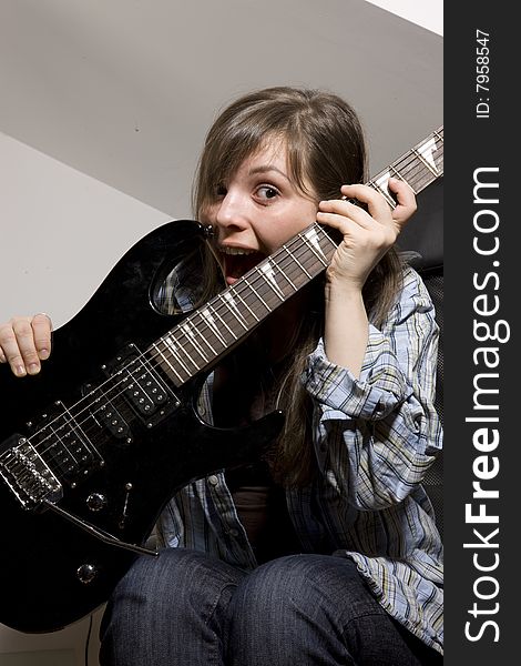 Young woman playing in guitar. Young woman playing in guitar