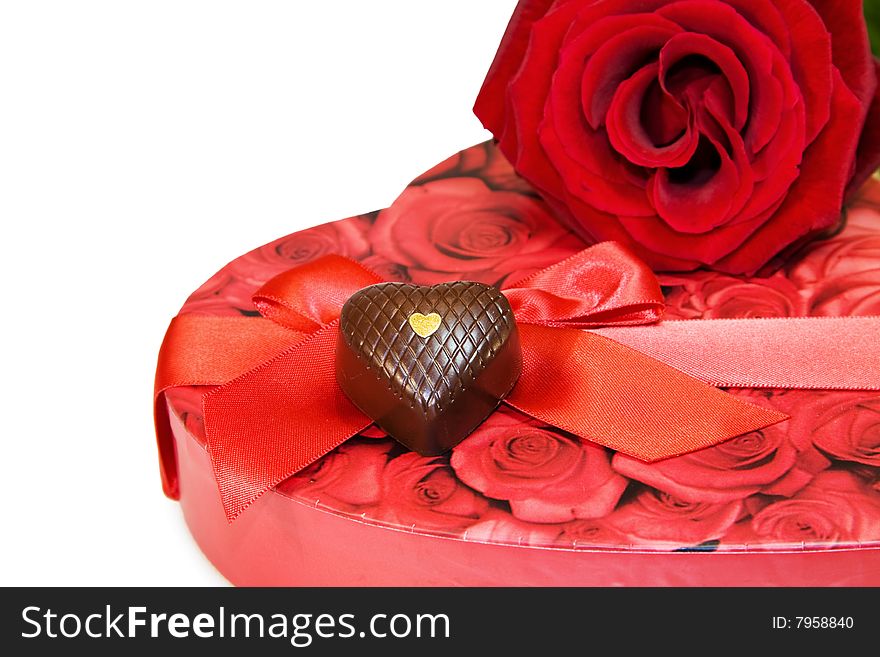 Celebrating Love - red rose and heart shaped box of chocolates isolated over white. Clipping path included at original size. Celebrating Love - red rose and heart shaped box of chocolates isolated over white. Clipping path included at original size.