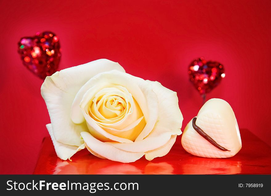 Passionate love - white rose and sparkling hearts over red background. Passionate love - white rose and sparkling hearts over red background.