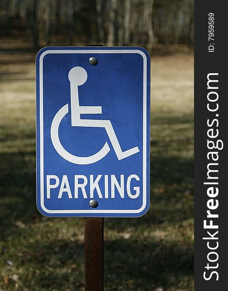 A sign showing a reserved parking space for individuals with a handicap. A sign showing a reserved parking space for individuals with a handicap.
