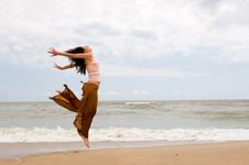 Happy Woman Is Jumping In Beach Royalty Free Stock Image