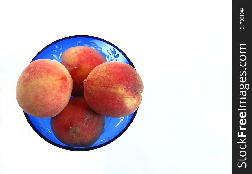 Four peaches in the round blue vase from top view isolated. Four peaches in the round blue vase from top view isolated