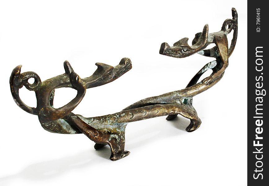 Old figurine made of bronze in the form of two dragons