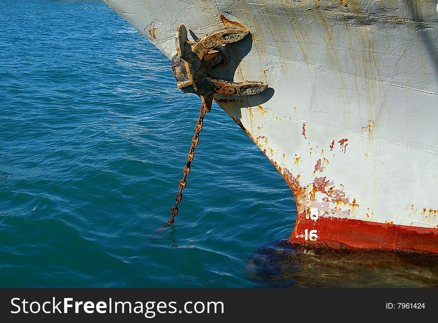 Rusty anchor and chain at the seaport