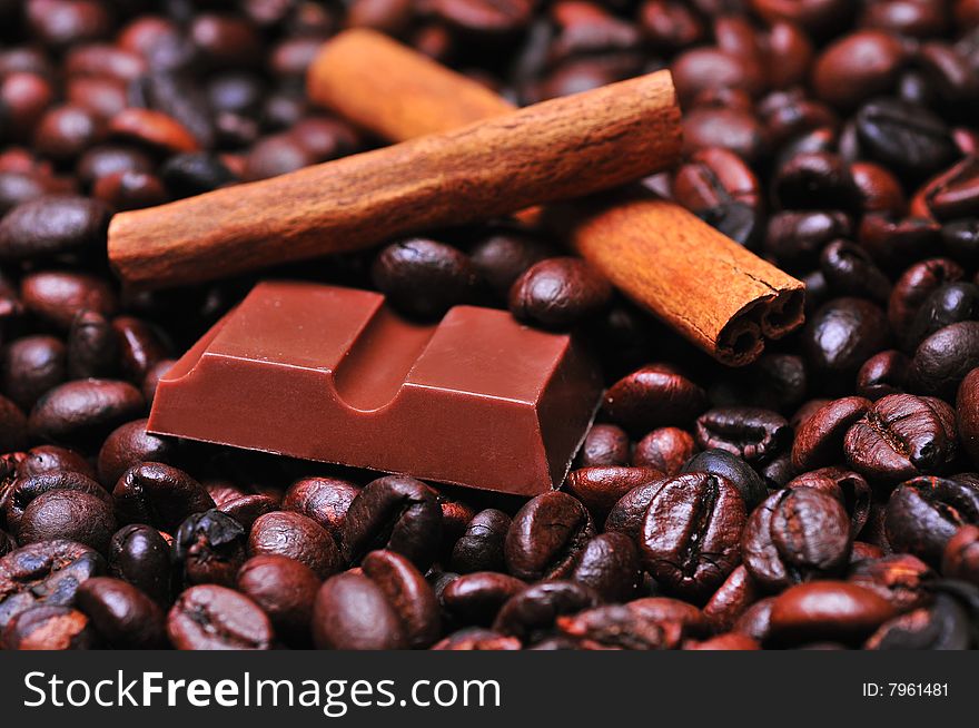 Close up of a coffee beans and chocolate with cinnamon. Close up of a coffee beans and chocolate with cinnamon
