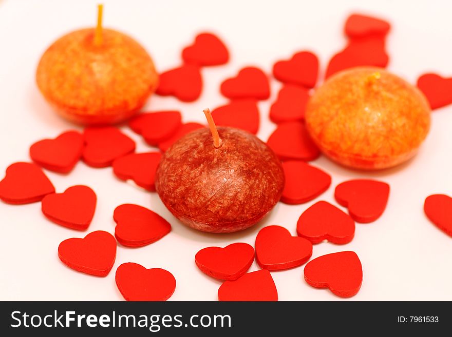 Brown and orange candlesticks and  hearts on white background. Brown and orange candlesticks and  hearts on white background