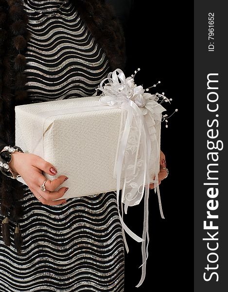 Gift in a white box with a beautiful bow on a black background. Gift in a white box with a beautiful bow on a black background.