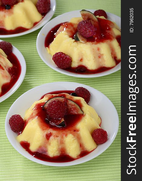 Panacota with fresh raspberries in bowls on table