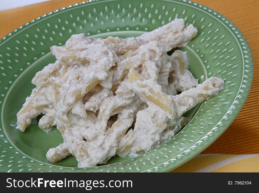 Macaroni in white cream sauce  on plate