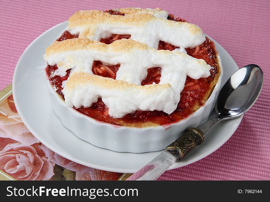 Small baked pie with red jam on plate