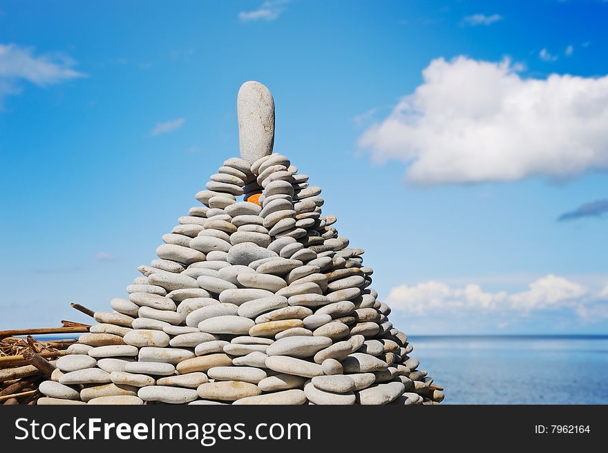 Pyramid from a sea pebble with a stone at top. Pyramid from a sea pebble with a stone at top