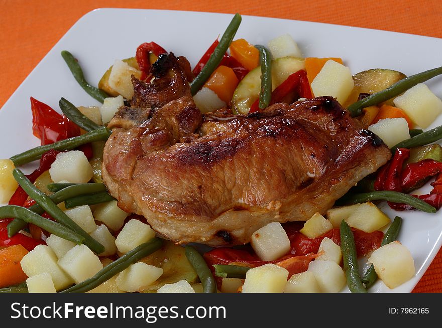 Filled pork cutlet on boiled potatoes on plate