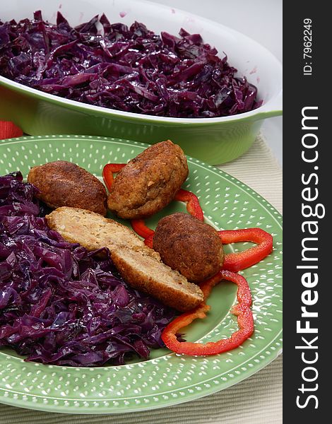 Fresh red cabbage with meat on plate