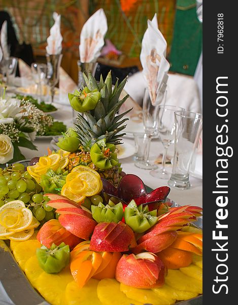 Dish with a fruit dessert on a beautiful celebratory table. Dish with a fruit dessert on a beautiful celebratory table.