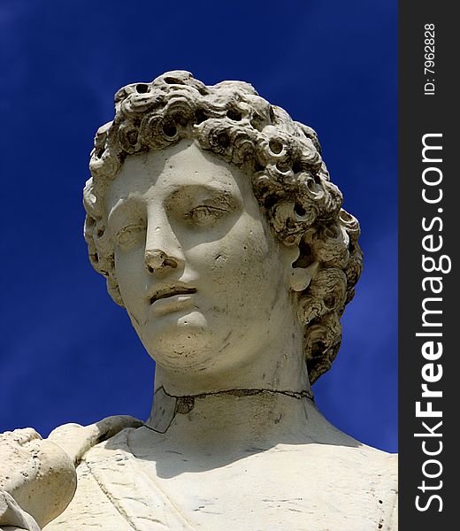 Statue of a young man in Versailles Gardens in France