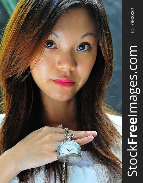 Modern Chinese Woman Showing A Watch Telling Time