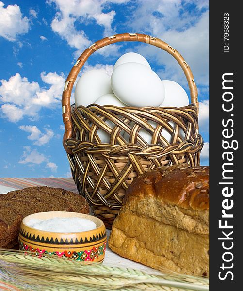 Easter food -eggs, bread and salt on sky background. Easter food -eggs, bread and salt on sky background