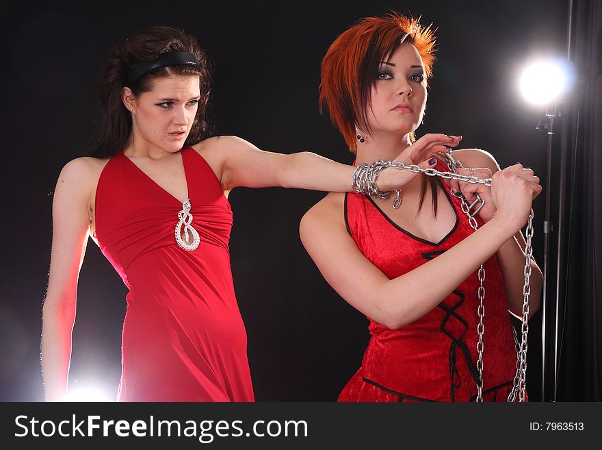 Two young models posing in the studio with backlights. Two young models posing in the studio with backlights