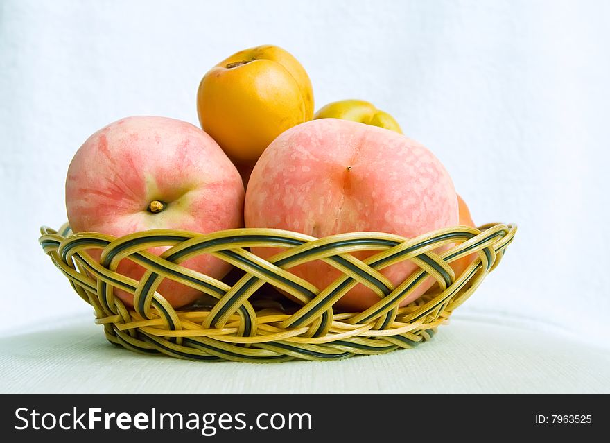 Plum and peach fruit in basket