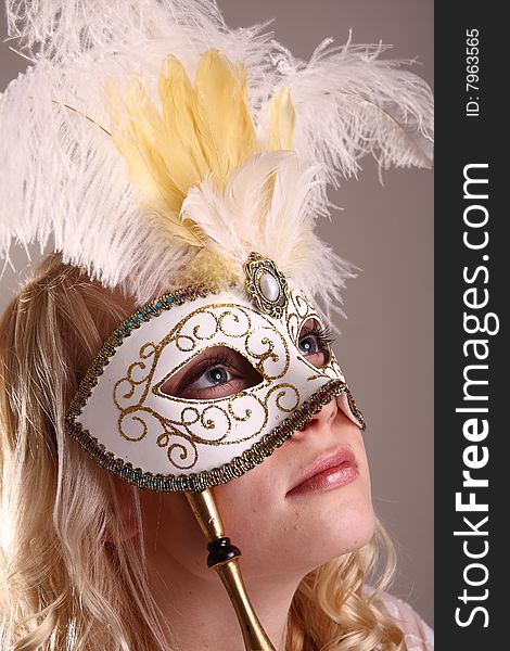 Beautiful young woman with Venetian mask, studio photo. Beautiful young woman with Venetian mask, studio photo