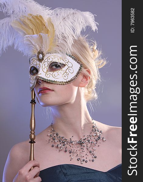 Beautiful young woman with Venetian mask, studio photo. Beautiful young woman with Venetian mask, studio photo