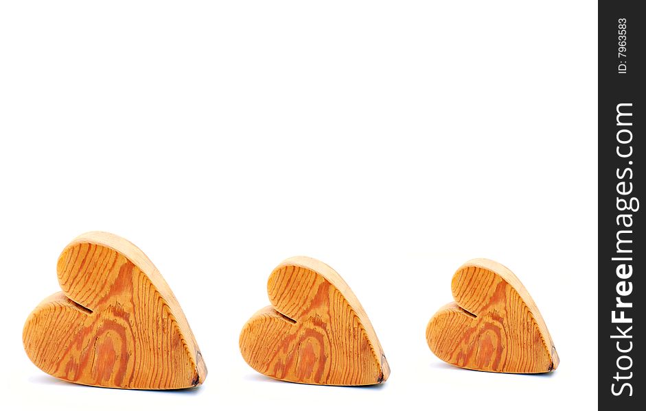 Three wooden hearts on a white background
