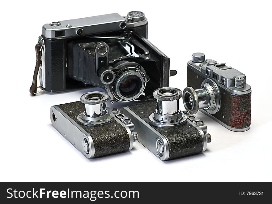 Old photo cameras on white background