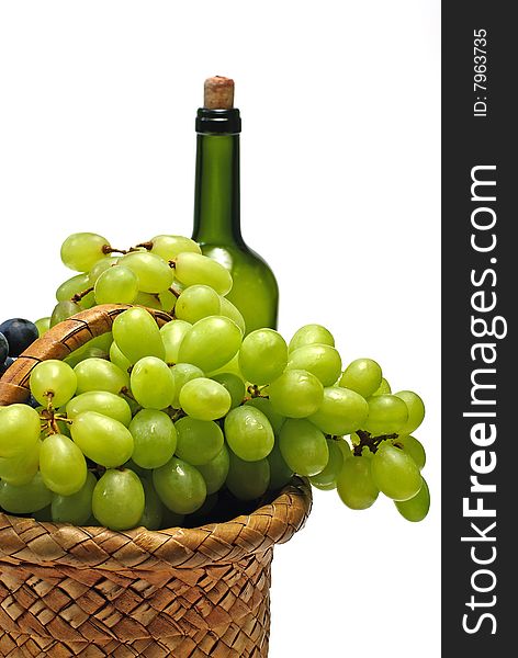 Grape in wooden basket and bottle on white. Grape in wooden basket and bottle on white