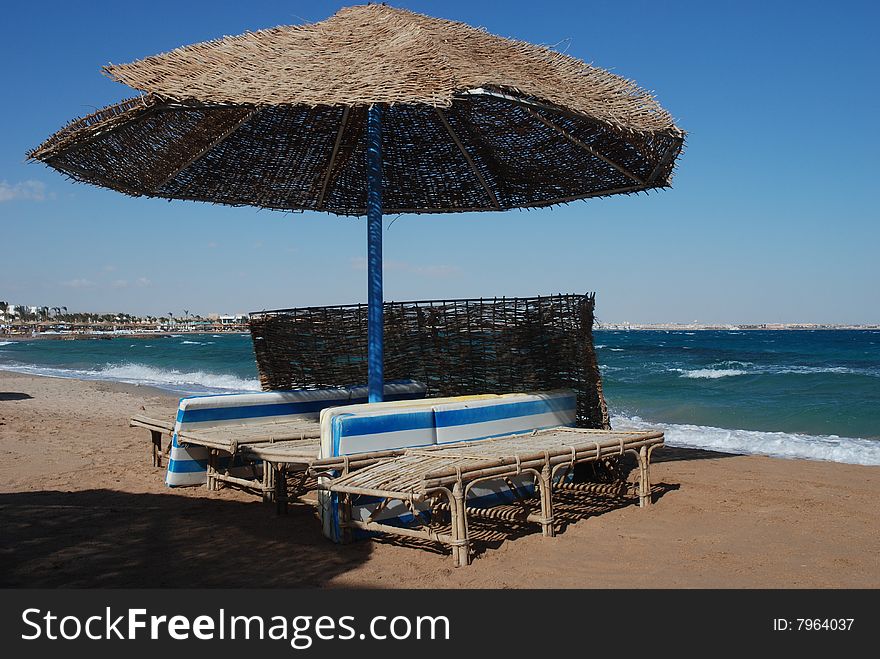 Umbrella on the beach with sea behind