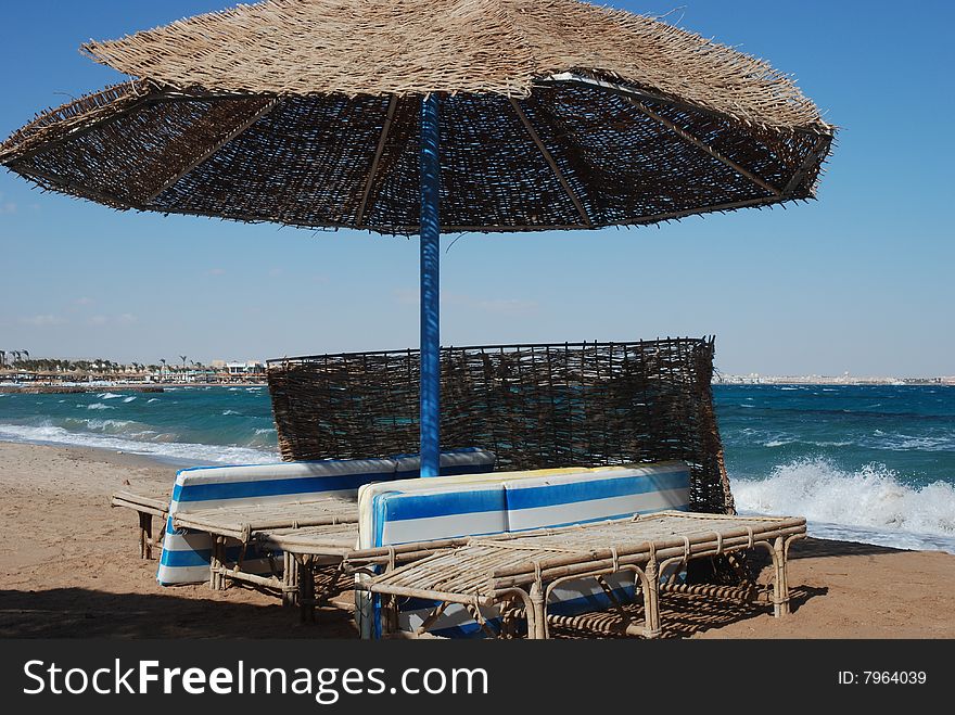 Umbrella on the beach with sea behind