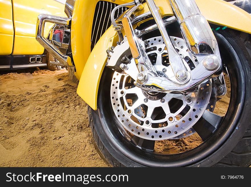 Wheel of ecellent yellow motorbike on the sand. Wheel of ecellent yellow motorbike on the sand
