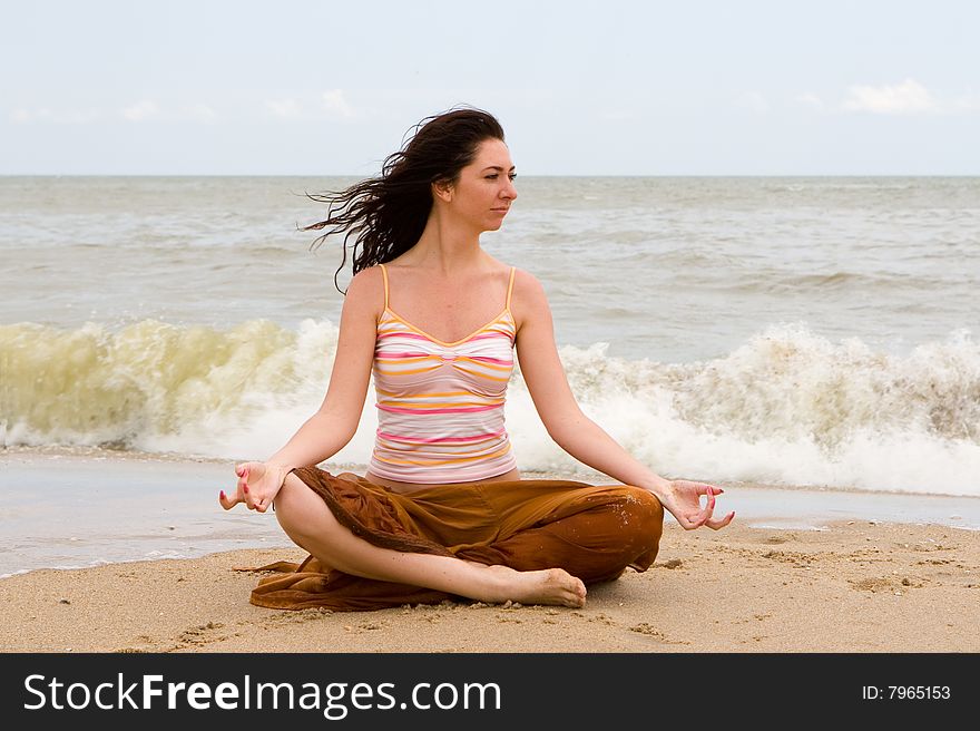 Girl meditation in the beach