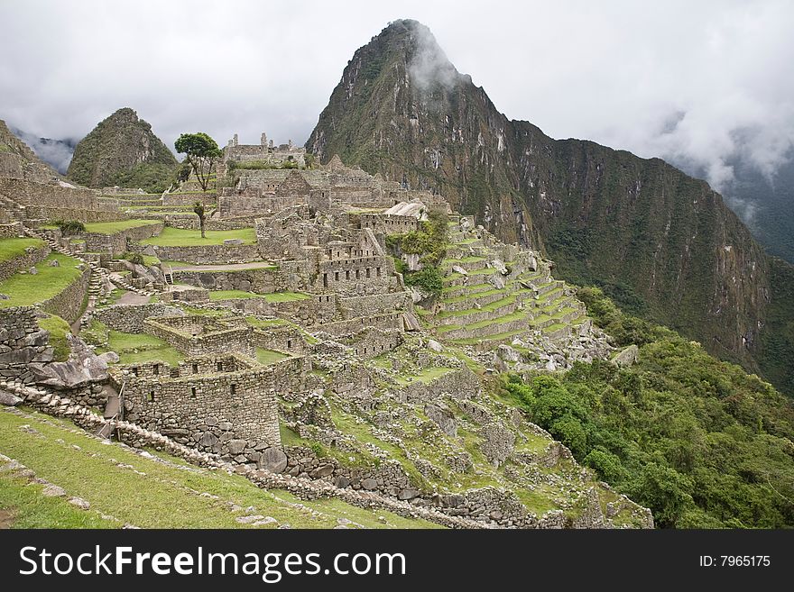 Machu Picchu is a pre-Columbian Inca site located 2,430 metres (8,000 ft) above sea level. It is situated on a mountain ridge above the Urubamba Valley in Peru, which is 80 kilometres (50 mi) northwest of Cusco and through which the Urubamba River flows. The river is a partially navigable headwater of the Amazon River. Often referred to as The Lost City of the Incas, Machu Picchu is one of the m