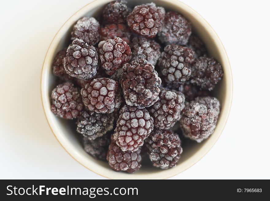 Clay plate with the frozen blackberry