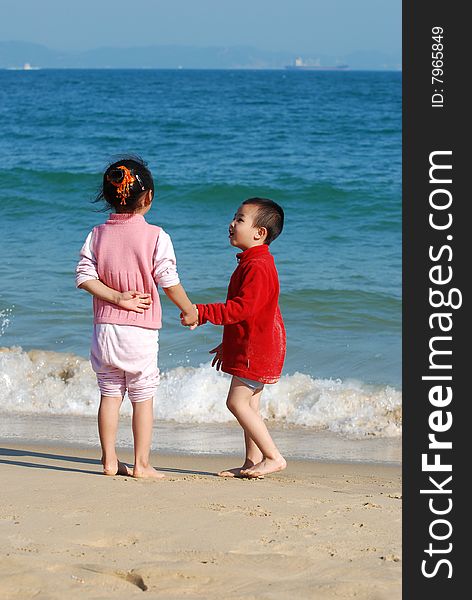 Young Kids Playing in the surfy beach