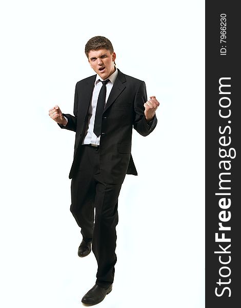 Young successfull businessman with his arms raised on white background.