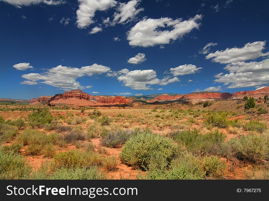 View of the red rock formations in Capitol Reef National Park with blue sky�s and clouds. View of the red rock formations in Capitol Reef National Park with blue sky�s and clouds