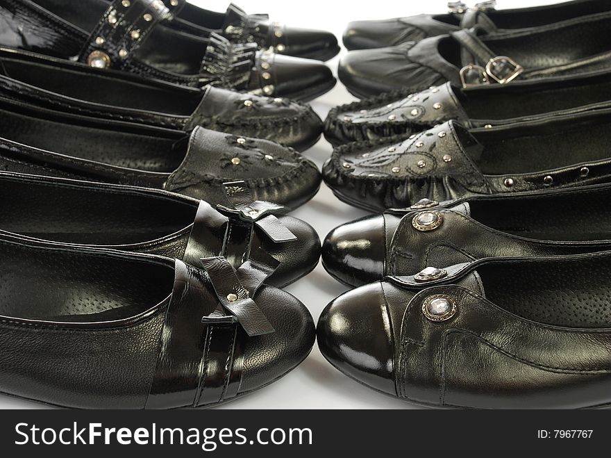 There is black shining shoes for wearing. There is black shining shoes for wearing