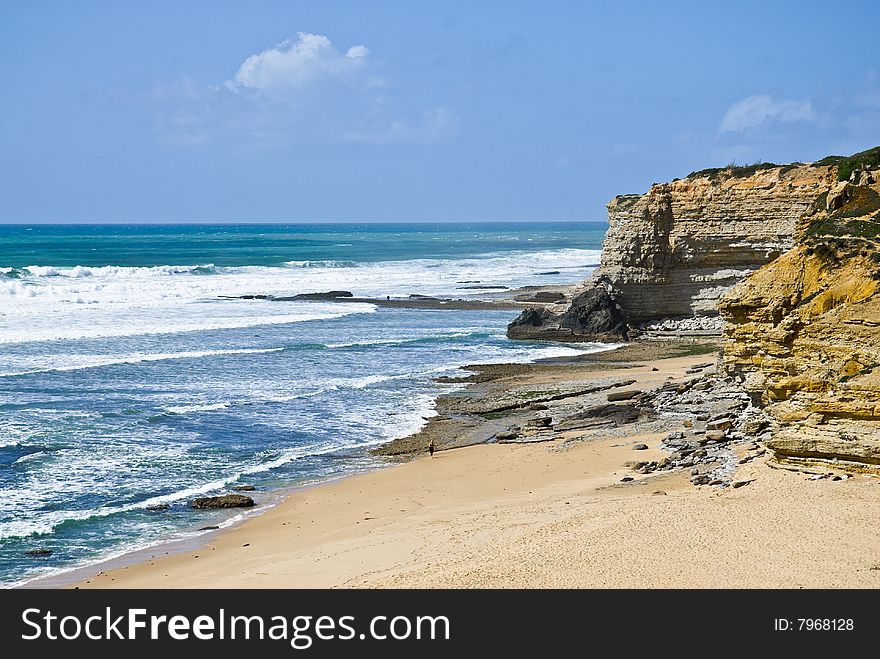 Deserted Beach Near The Rocks