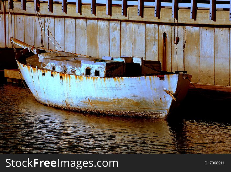 Old cement boat docked at half moon bay harbor.