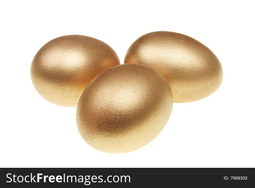 Three golden eggs isolated on white. Three golden eggs isolated on white