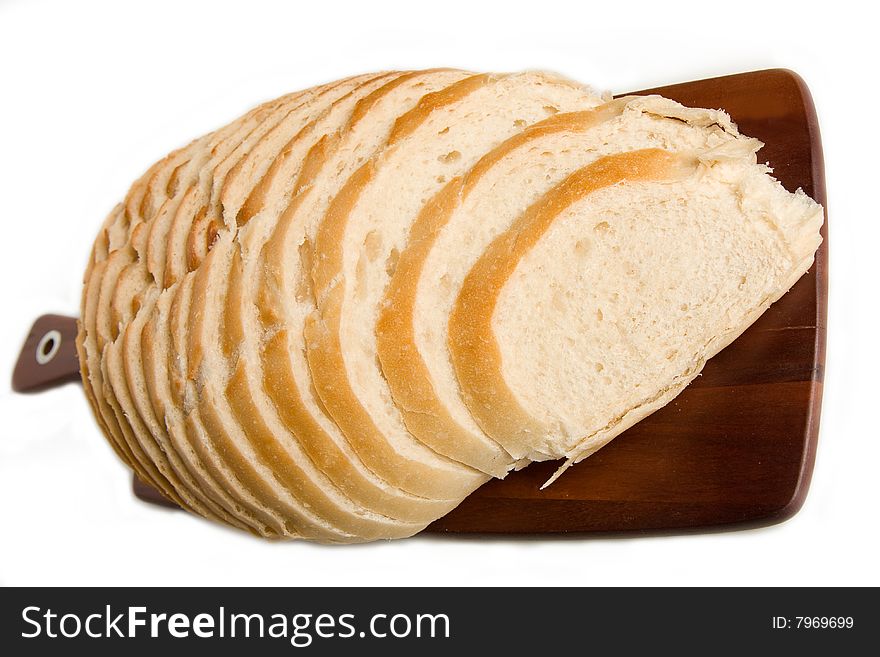 Large Loaf of isolated sourdough bread resting on Acacia bread board. Large Loaf of isolated sourdough bread resting on Acacia bread board