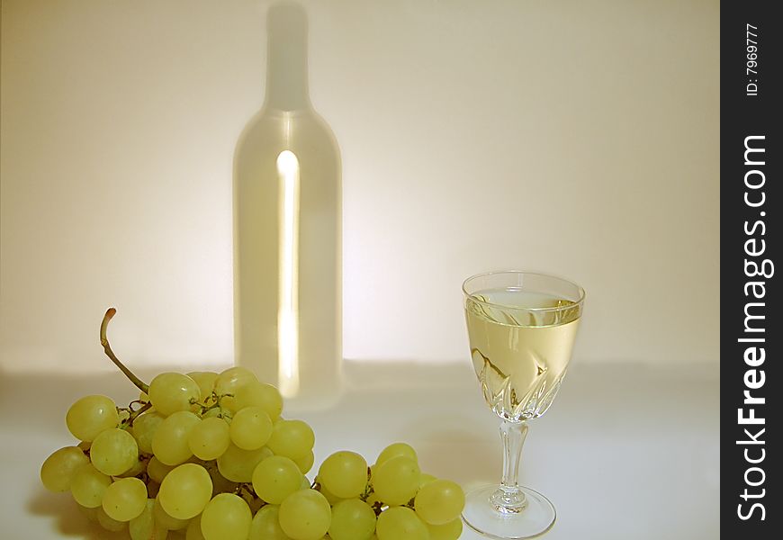 Wineglass, bunch of grapes and silhouette of bottle with white wine. Wineglass, bunch of grapes and silhouette of bottle with white wine.