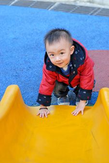 The Asian Boy Playing The Sliding Board Stock Photography The Asian Boy Playing The Sliding Board Stock Photography