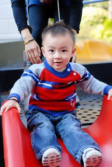 The Asian Boy Playing The Sliding Board Stock Image The Asian Boy Playing The Sliding Board Stock Image